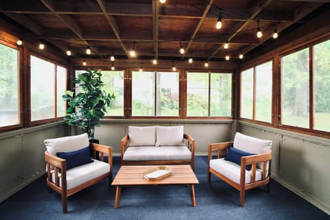 Just off the kitchen and dining room, this covered patio offers a seamless indoor-outdoor living experience. Furnished with comfortable lounge chairs and a cozy outdoor couch, it’s the perfect spot to start your day with a quiet cup of coffee, enjoy an afternoon snack, or wind down with evening cocktails.

String bistro lights cast a warm, inviting glow over the space, creating...