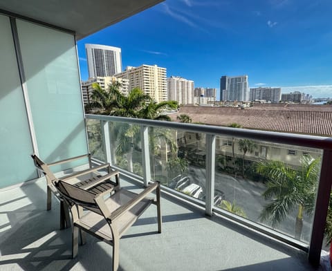 Private balcony with chairs and open city views.