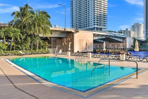 Outdoor pool surrounded by high-rises and cityscape views.