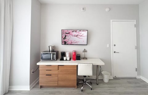 Well-equipped workspace and TV area inside the bedroom.