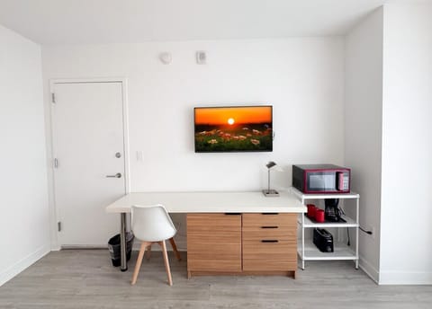 Well-equipped workspace and TV area inside the bedroom.