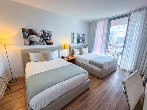 Spacious bedroom with balcony access and Smart TV.