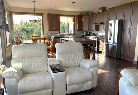 Open concept: Living room, kitchen & dining room, 60-inch smart TV