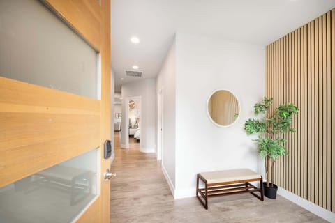 A convenient shoe bench and a full-length mirror offer both functionality and style for guests when entering home.