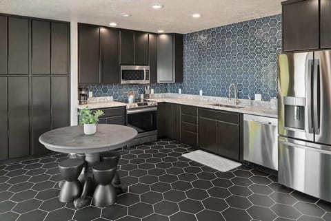 Cook up a feast in the sleek, modern kitchen with stunning backsplash.