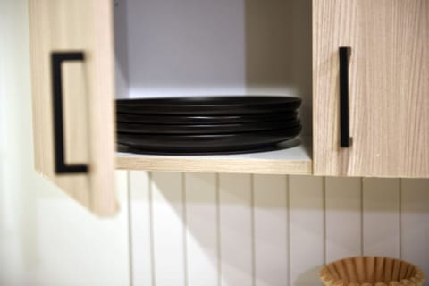 Kitchen cabinets stocked with cooking wares, glassware and silverwares, ideal for mixing up your favorite meals and drinks during your stay.