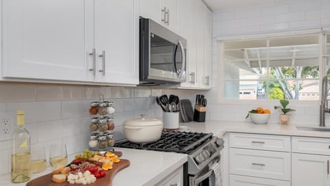 Fully stocked renovated kitchen with loads of cookware and spacious counters.