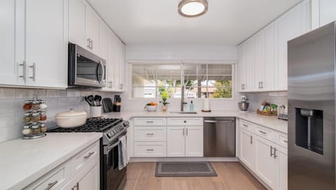 Bright remodeled kitchen with all the tools needed for cooking and baking.