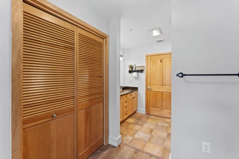 The primary bedroom features a king sized bed, mounted smartTV, and en suite bathroom.