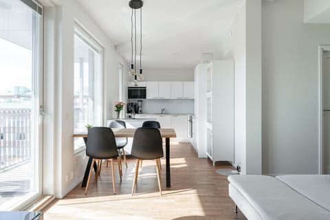 There is a spacious and bright dining area and kitchen at the apartment living room.