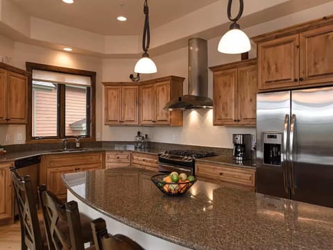- Cook up comfort in this fully equipped kitchen featuring granite counters and wood cabinetry
- Stainless steel appliances and coffee station make every morning a breeze
- Gather around the spacious island for laughs, meals, and planning the day