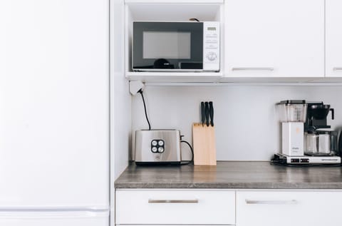 The apartment's kitchen is well-equipped and includes an oven, full-size fridge-freezer, stove, and dishwasher.