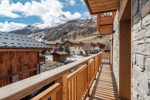 South-facing wooden balcony with unobstructed views of the peaks.