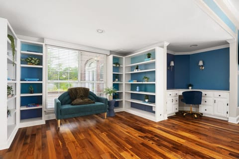 Peaceful reading and work corner with natural light, built-in bookshelves, and a cozy seating area—ideal for quiet mornings or focused remote work