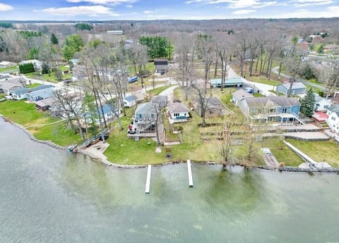 Aerial view of yellow cottage (center) and grounds
