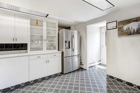 Whip up meals with ease in this bright, fully equipped kitchen featuring modern appliances, ample counter space, and classic cabinetry.