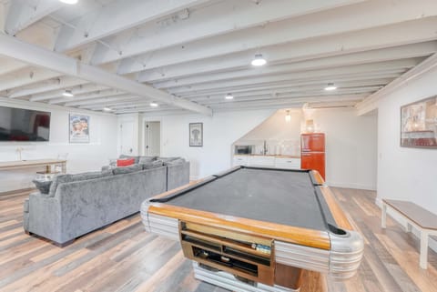 Lower‑level game room featuring a pool table, comfy seating and kitchenette for hours of entertainment.