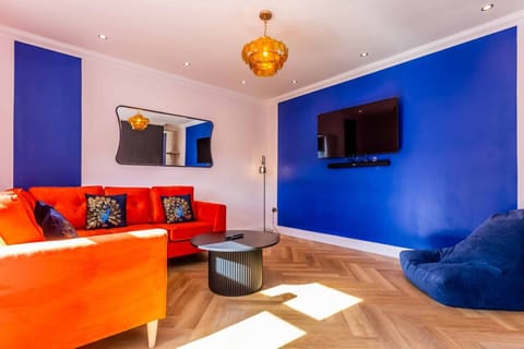 Vibrant living room vibes with bold colors and cozy seating!