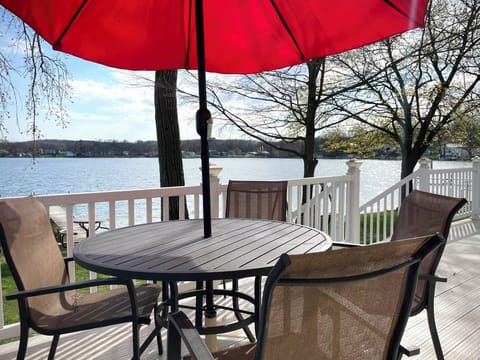 Relax under the umbrella on the back deck, perfect for meals or sipping drinks while soaking in the lake views.