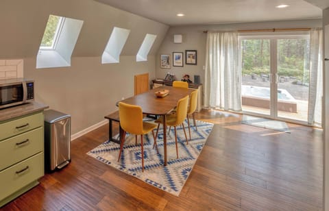 Dine with a view and easy hot tub access! This bright space is perfect for meals and relaxation. 