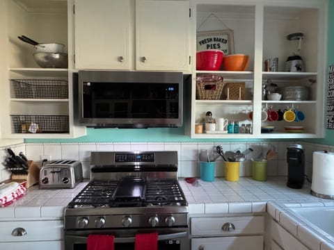 Fully stocked kitchen: stove, Keurig, cookware & spices for easy meals.