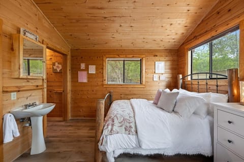 Perfect for families or small groups, this inviting room offers two queen beds, peaceful lake views, and a private entrance for added convenience.