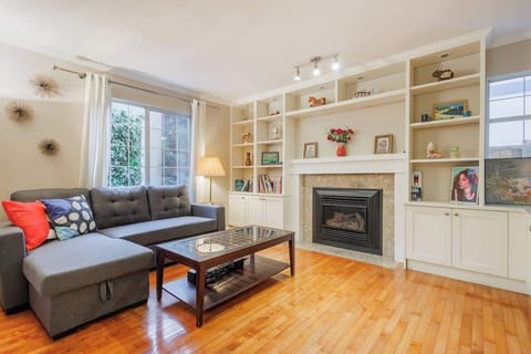 Relax and unwind in the cozy living area with a plush L-shaped sofa and smart TV.