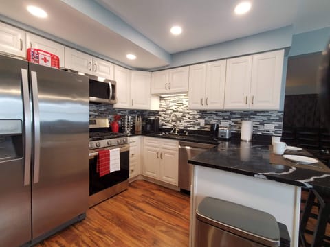 Kitchen has a dishwasher, stove, oven, microwave, ice maker, and more.