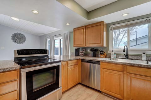Spacious kitchen with modern appliances, ample counter space, and a bright window view—perfect for preparing meals and gathering with loved ones.