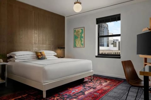 Arrive and exhale in a serene bedroom with bold rug