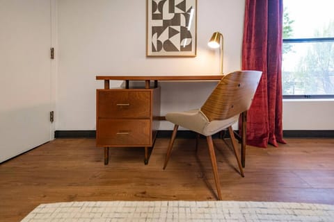 Comfort meets productivity in Bedroom 2, featuring a luxurious king bed and a convenient desk setup.