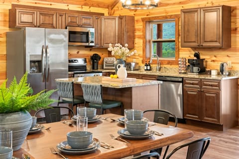 Fully equipped chef’s kitchen with granite countertops and bar seating.