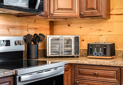 Kitchen with stainless steel appliances and all the essentials for home cooked meals. (House 1)