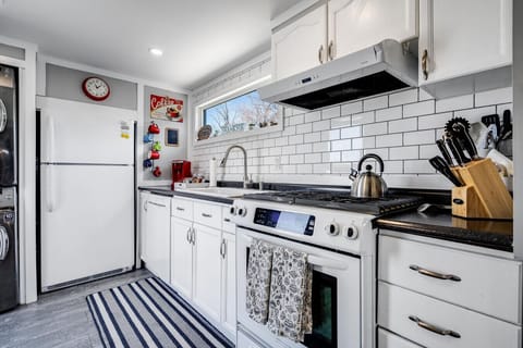 Galley Kitchen that features a gas stove/oven, dishwasher, microwave, full-sized fridge, and Keurig coffee maker.