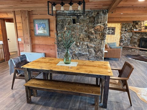 Dining table adjacent to open-area kitchen and island