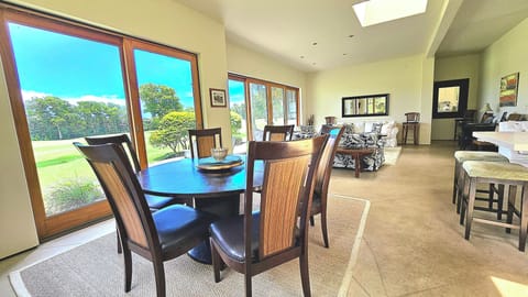 Formal 6 seat dining table with golf course Views and Living room setting.