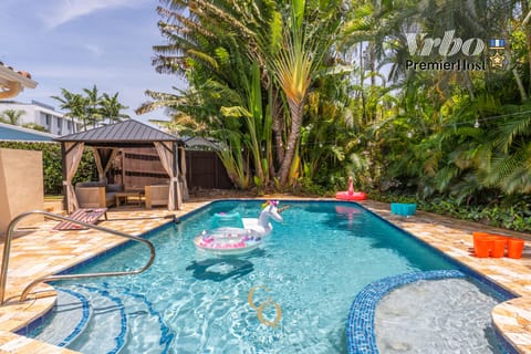 Relax on a unicorn float with lush greenery all around—pure vacation mode.