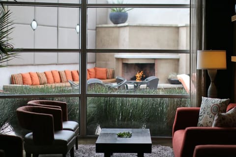 Settle into cozy seating overlooking a glowing outdoor fireplace.