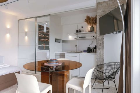 Dining Table Next to Open Kitchen & TV