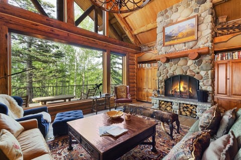 Beautiful Great room with high ceilings, wood burning fireplace and large flat screen TV for entertainment.