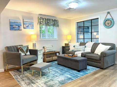 Stone Lake Cottage Retreat: A comfy place to unwind — pull-out sofa for extra guests, plus a cozy chair for solo coffee sipping.