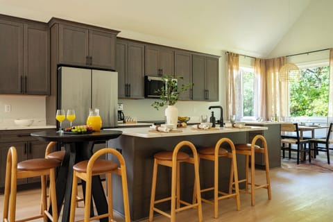 Fully stocked kitchen with sleek stainless appliances and plenty of seating.