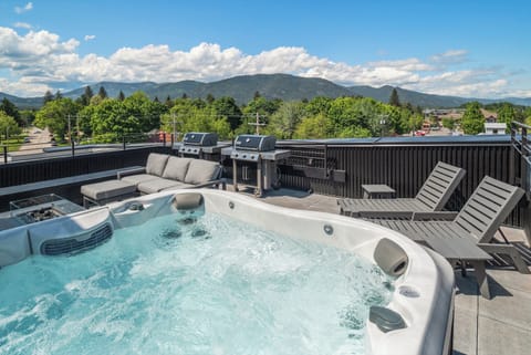 Large hot tub on rooftop deck.