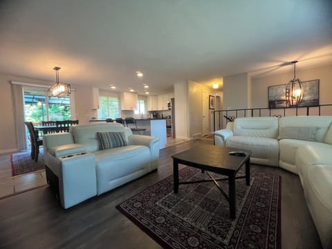 The living room with three leather recliner chairs, sofa and loveseat. 