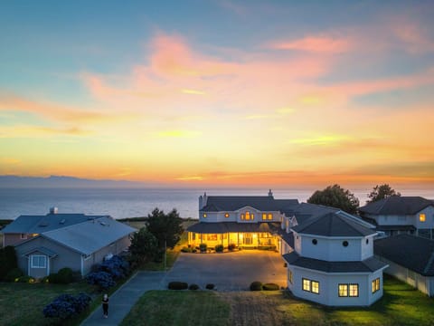 Charming waterfront home glowing warmly at dusk.