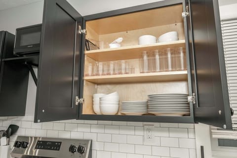 The sleek, open kitchen offers ample space & every home comfort