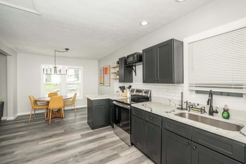 The sleek, open kitchen offers ample space & every home comfort