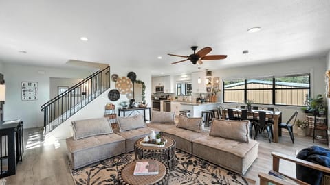 The living room’s massive sectional keeps everyone comfy, with an open floor plan perfect for gathering and fun.