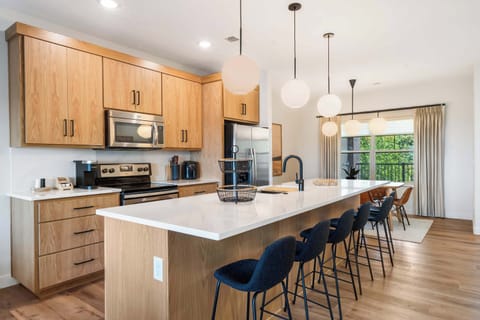 The chic, open kitchen offers ample space & every home comfort