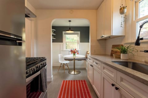 Galley kitchen with stainless steel appliances, ample counter space, and modern fixtures.